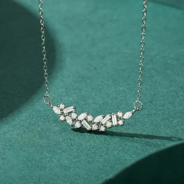 Silver necklace with diamond-like stones on a green background-Crystal Cascade Pendant - TM & CO. JEWELS 