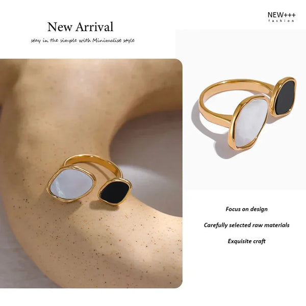 Gold-plated adjustable ring with black and white stones on textured surface