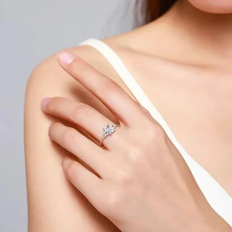 Woman wearing a 925 silver engagement ring with clear gemstone on left hand