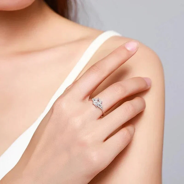 Woman wearing a 925 silver ring with a large clear gemstone on her hand