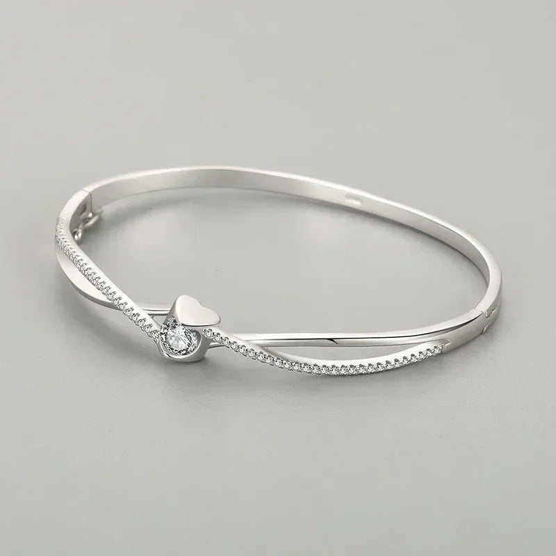 Elegant 925 silver bangle with a heart and crystal center, minimalist jewelry for women