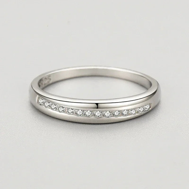 925 silver ring with a row of small clear stones on a smooth band, elegant jewelry