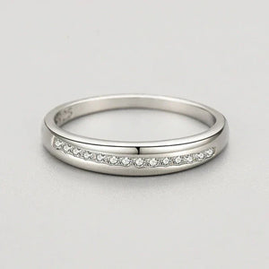 925 silver ring with a row of small clear stones on a smooth band, elegant jewelry