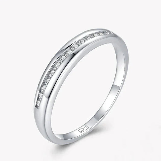 Sterling silver ring with channel-set small clear stones, minimalist design on white background