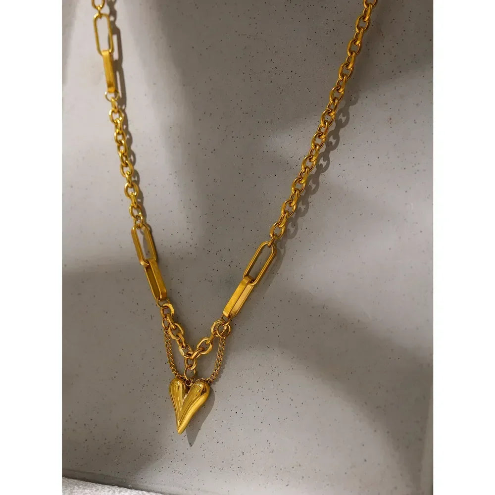 18K gold-plated chain necklace with heart pendant on neutral background