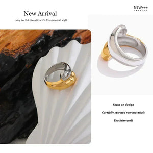 Two rings, one gold and one silver, on a white shell with text about new arrival and fashion brand.