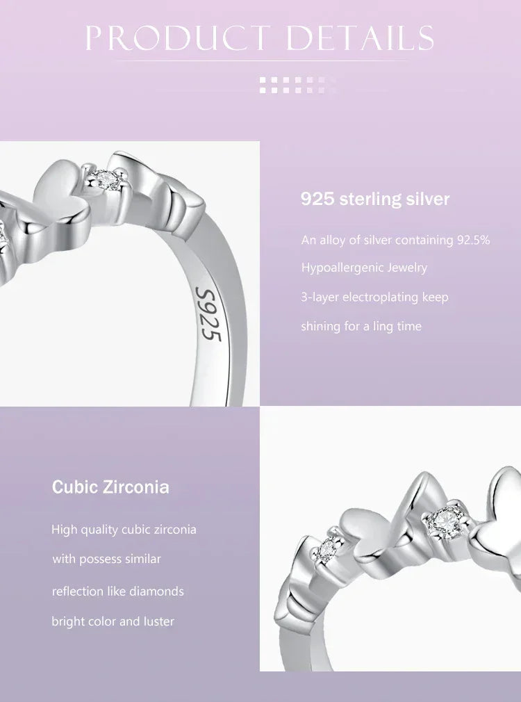 Sterling silver ring with bow-shaped design and cubic zirconia accents on a light purple background.