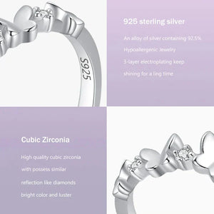 Silver ring with cubic zirconia on a light purple background, featuring product details.