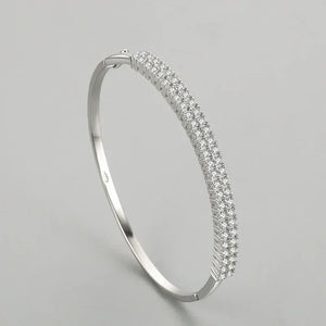 925 sterling silver bangle with triple row pavé cubic zirconia on a plain background