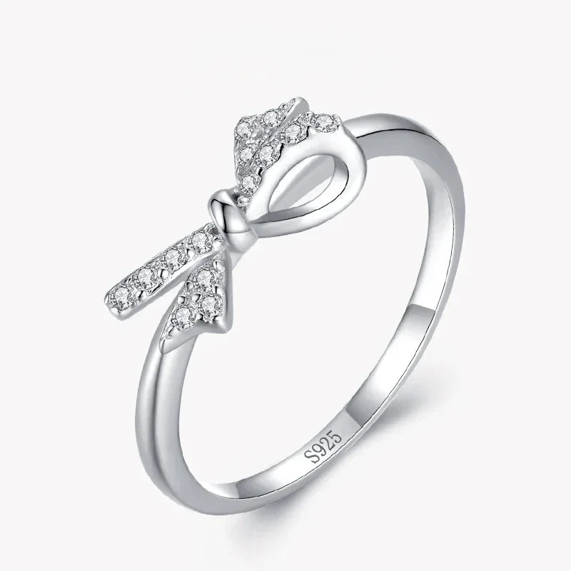 Sterling silver bow ring with cubic zirconia accents on a white background