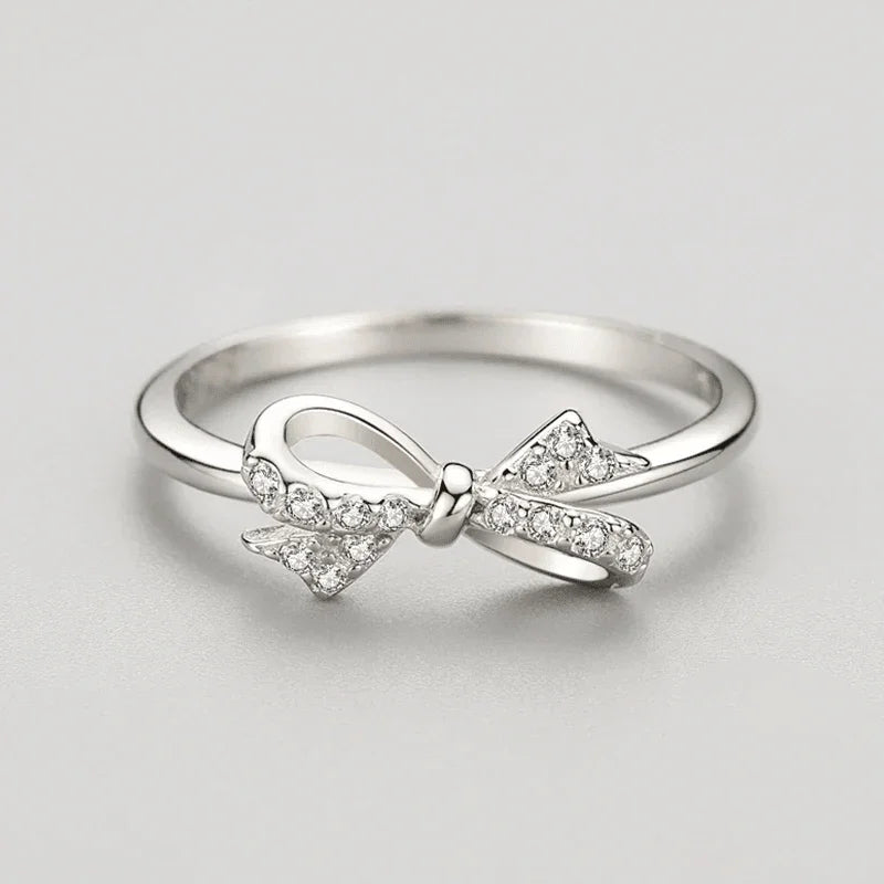 Sterling silver ring with a bow design and sparkling cubic zirconia accents