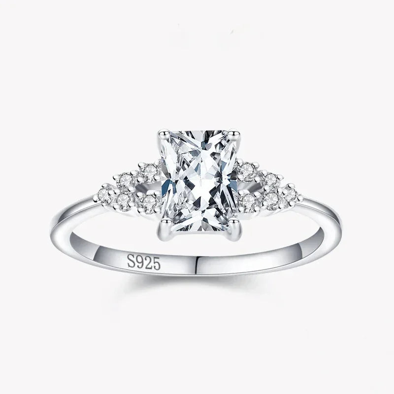 925 silver ring with rectangular clear center stone and small round gemstones on band