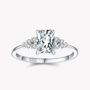 925 silver ring with rectangular clear center stone and small round gemstones on band