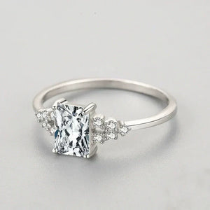 Sterling silver ring with rectangular clear stone and small accent crystals on band