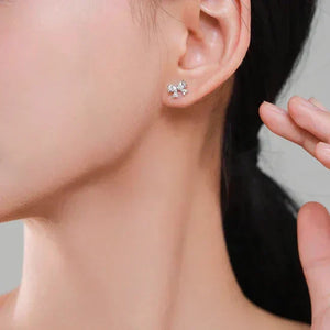 Close-up of a person wearing Elegance Earrings - TM & Co. Jewels-with a small gemstone.