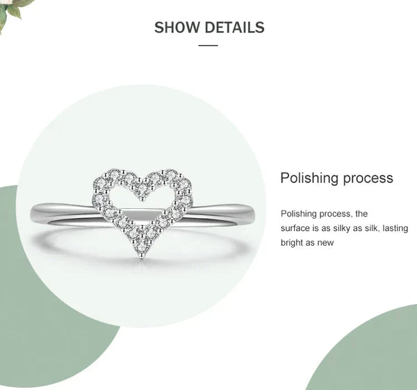 Silver ring with heart-shaped diamond design on a white background