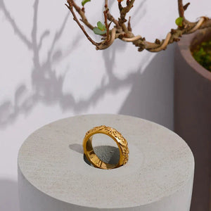 18K gold-plated ring with engraved sun, moon, and star motifs, accented with small crystals