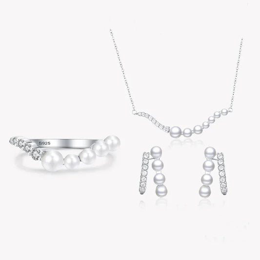 925 silver jewelry set with pearl accents, including a necklace, ring, and earrings on white background