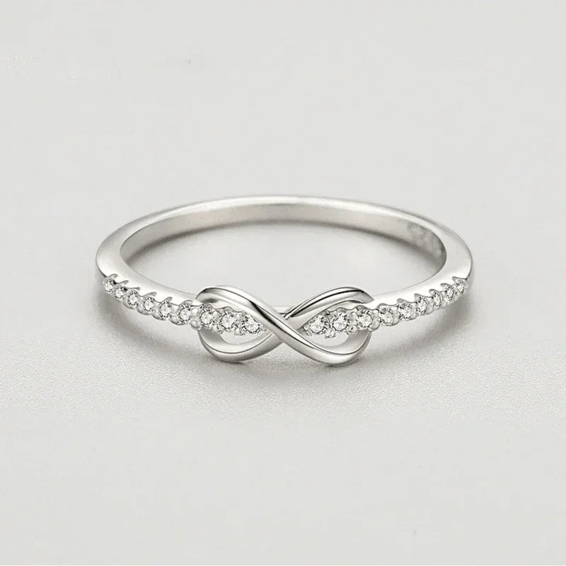 925 silver infinity ring with cubic zirconia accents on a plain background