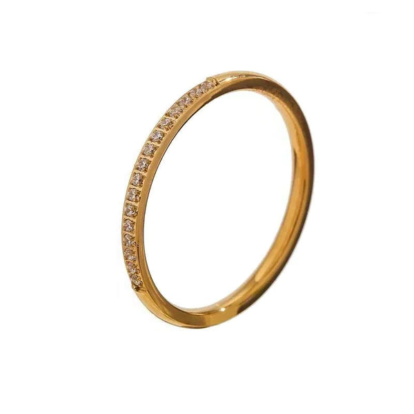 18K gold-plated slim ring with embedded sparkling stones on white background