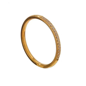 Gold ring with small diamonds on a white background