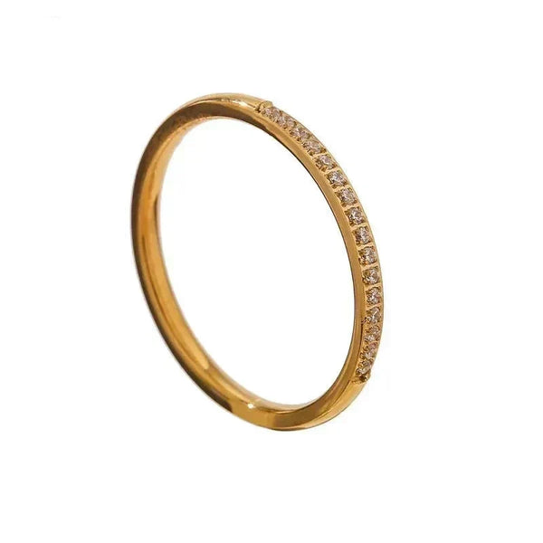 Gold ring with small diamonds on a white background