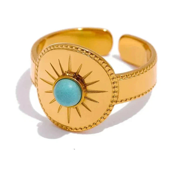 Gold bracelet with turquoise stone on a white background