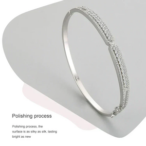 Silver bracelet on a gray stand with polishing text- Ava Heart Bands - TM & CO. JEWELS 