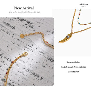 Gold necklaces on a textured surface with 'NEW++' branding.