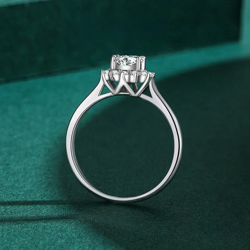 925 silver solitaire ring with round gemstone on green background