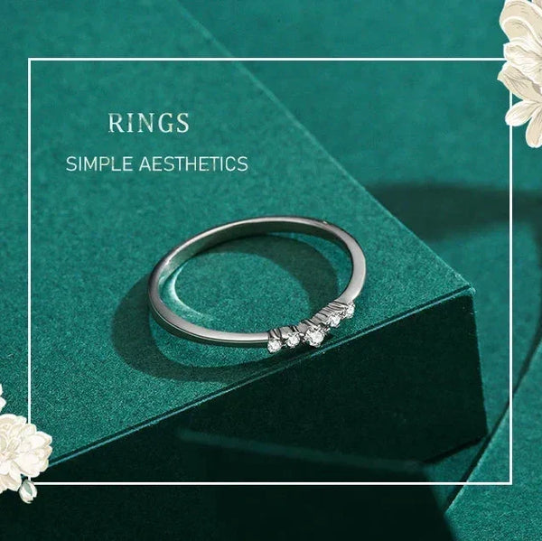 Silver ring with small stones on a green box with floral decorations-TM & CO. JEWELS .