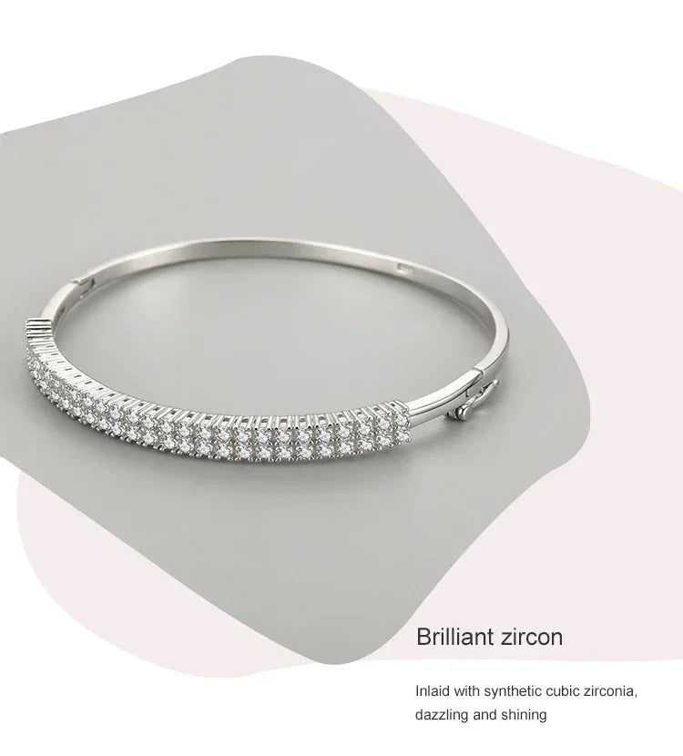925 silver bangle with rows of sparkling cubic zirconia stones on a light gray background
