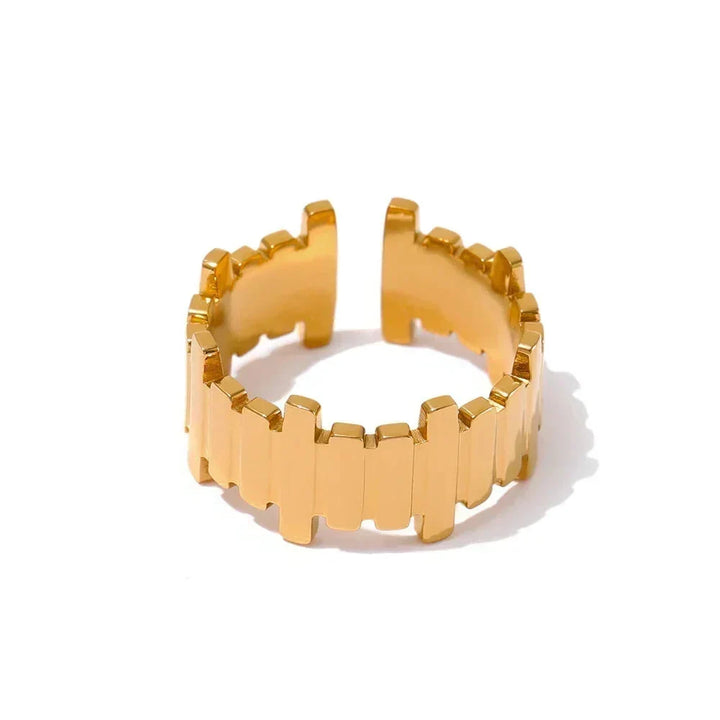 Gold ring with geometric design on a white background