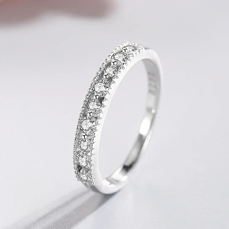 Sterling silver ring with round-cut clear stones set in a single row, elegant jewelry