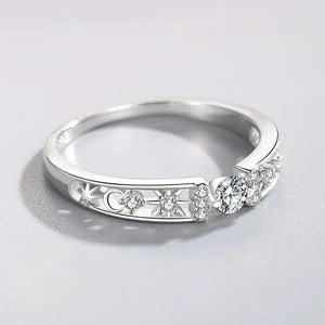 Sterling silver ring with round clear stones and engraved star and moon details