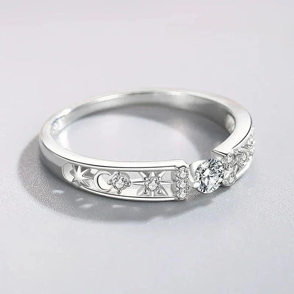 Sterling silver ring with round clear stones and engraved star and moon details