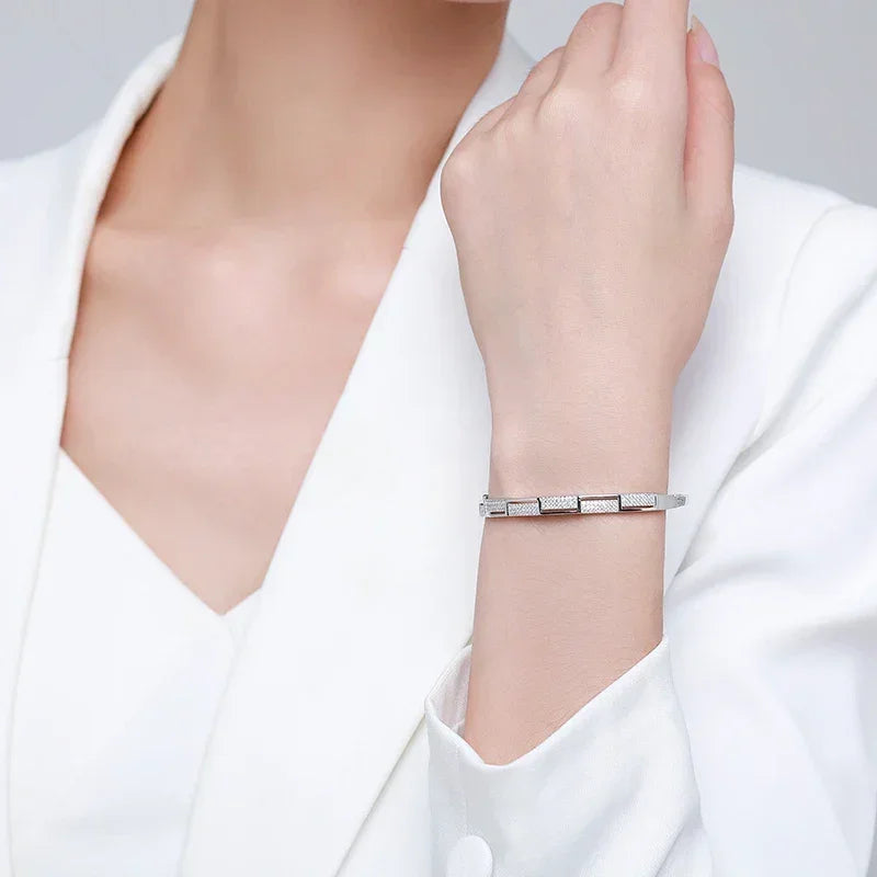 Elegant woman wearing a geometric 925 silver bracelet, perfect for formal occasions.