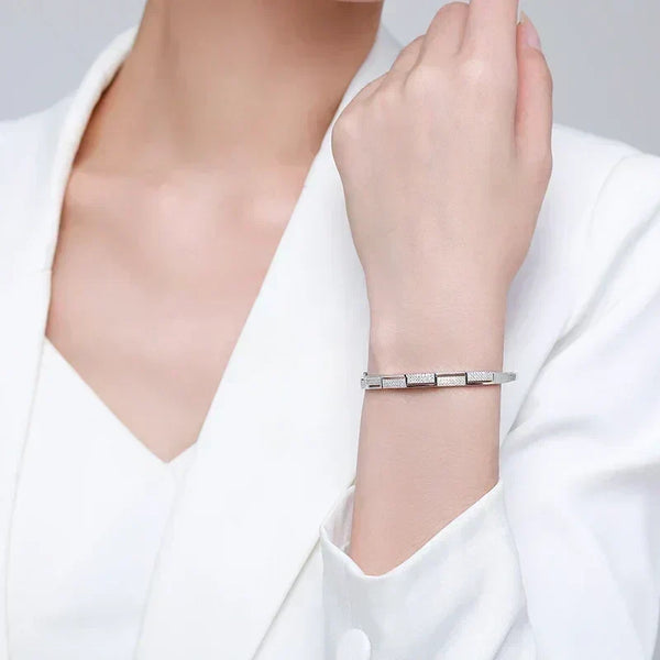 Elegant woman wearing a geometric 925 silver bracelet, perfect for formal occasions.