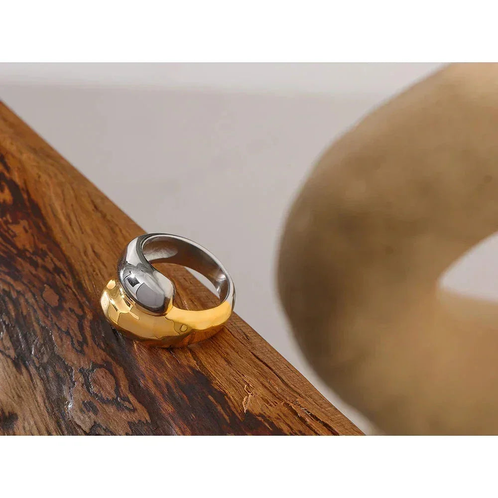 Chunky two tone ring in 925 sterling silver and 18K gold plating on wooden surface