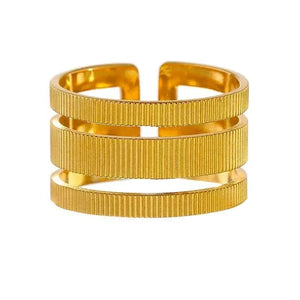 Gold bracelet with a ribbed texture on a white background