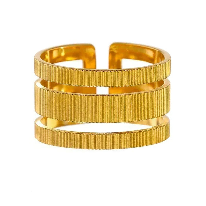 Gold bracelet with a ribbed texture on a white background