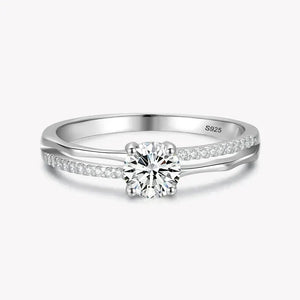 925 silver ring with round solitaire center and pavé set stones on split band.