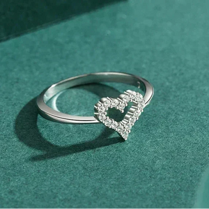 Silver ring with a heart-shaped diamond on a teal background-TM & CO. JEWELS 
