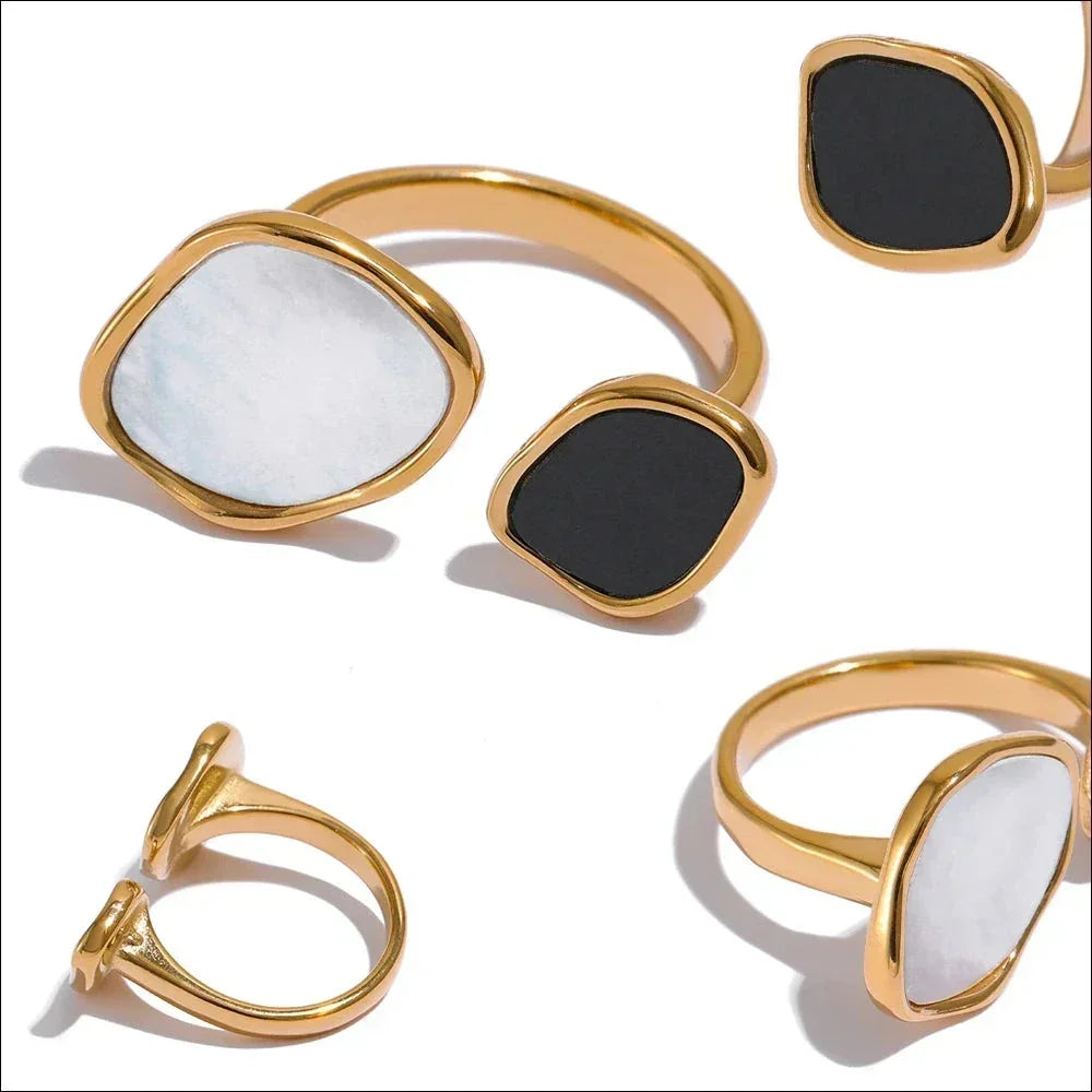 Gold-plated adjustable ring with black and white stone accents on a white background