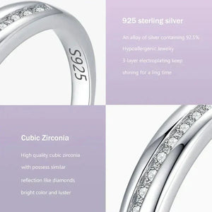 Close-up of a 925 sterling silver ring with cubic zirconia stones set in a row, shiny finish.