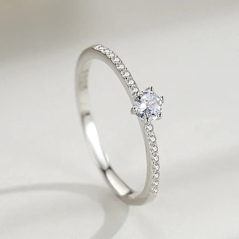 Elegant 925 silver engagement ring with round solitaire and pavé set stones for women