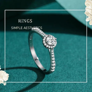 Sterling silver ring with round center cubic zirconia and pavé band on white background