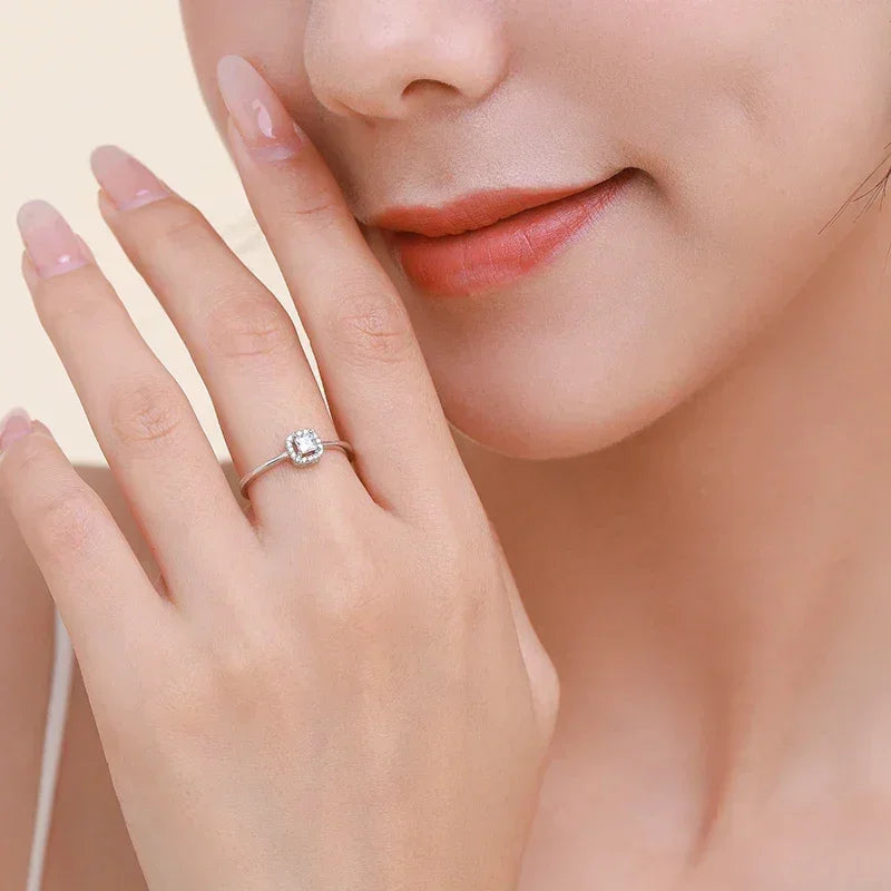 Elegant woman wearing a silver solitaire ring with a clear gemstone close to her face
