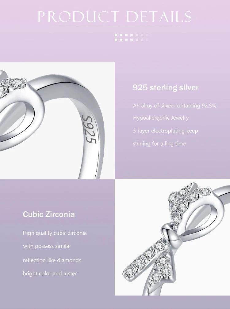 925 sterling silver ring with cubic zirconia bow detail on a gradient purple background