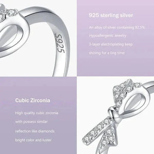 925 sterling silver ring with cubic zirconia bow detail on a gradient purple background